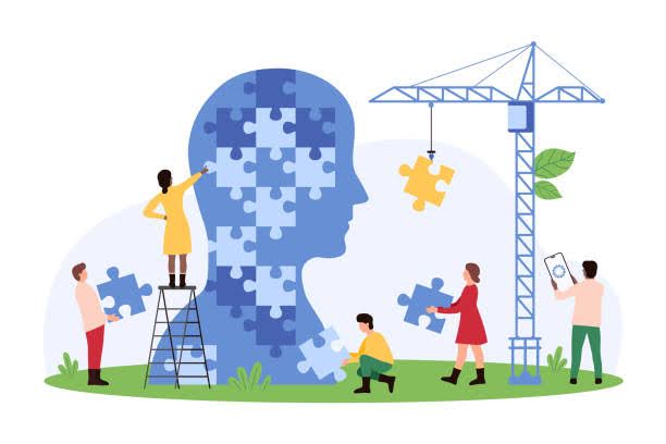 people completing the puzzle of a human head
